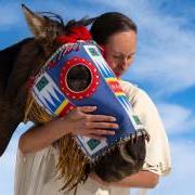 A member of the Lakota nation hugging a horse's head